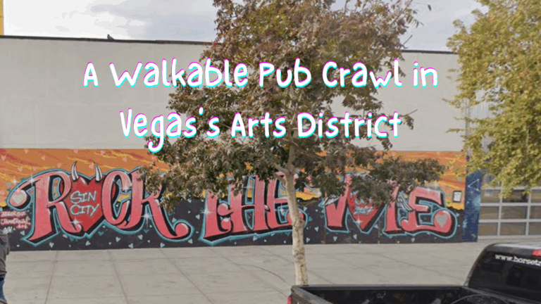 Street art mural reading "Rock the Vote" in Las Vegas Arts District, with trees partially obscuring the wall