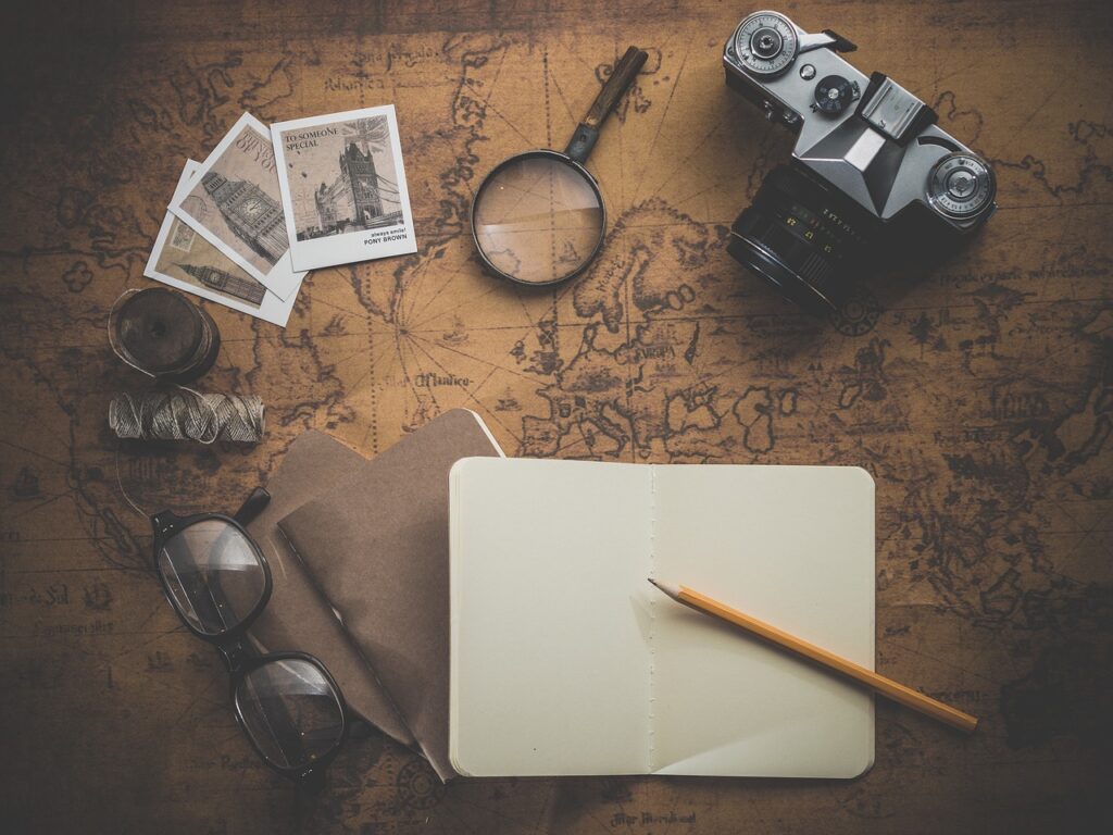 Books and camera on a table — a quiet moment of travel planning