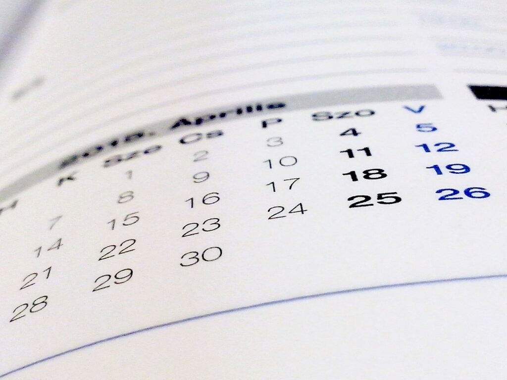 A soft-focus photo of a monthly calendar, representing building a blog post queue and planning ahead with breathing room