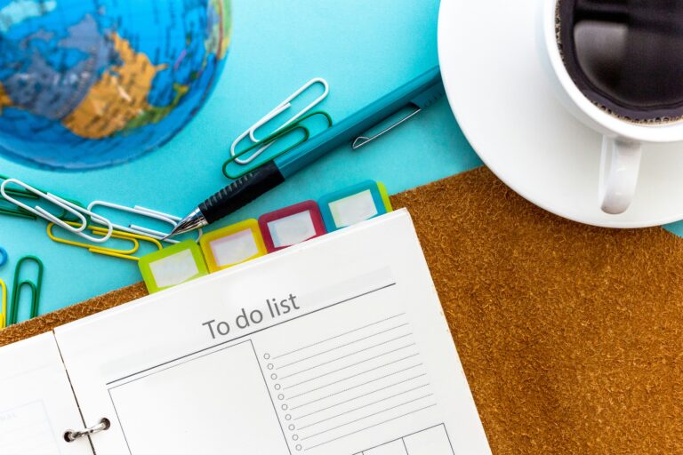 Open planner with to-do list, colorful tabs, pen, coffee cup, and globe — illustrating communicating with different learning styles